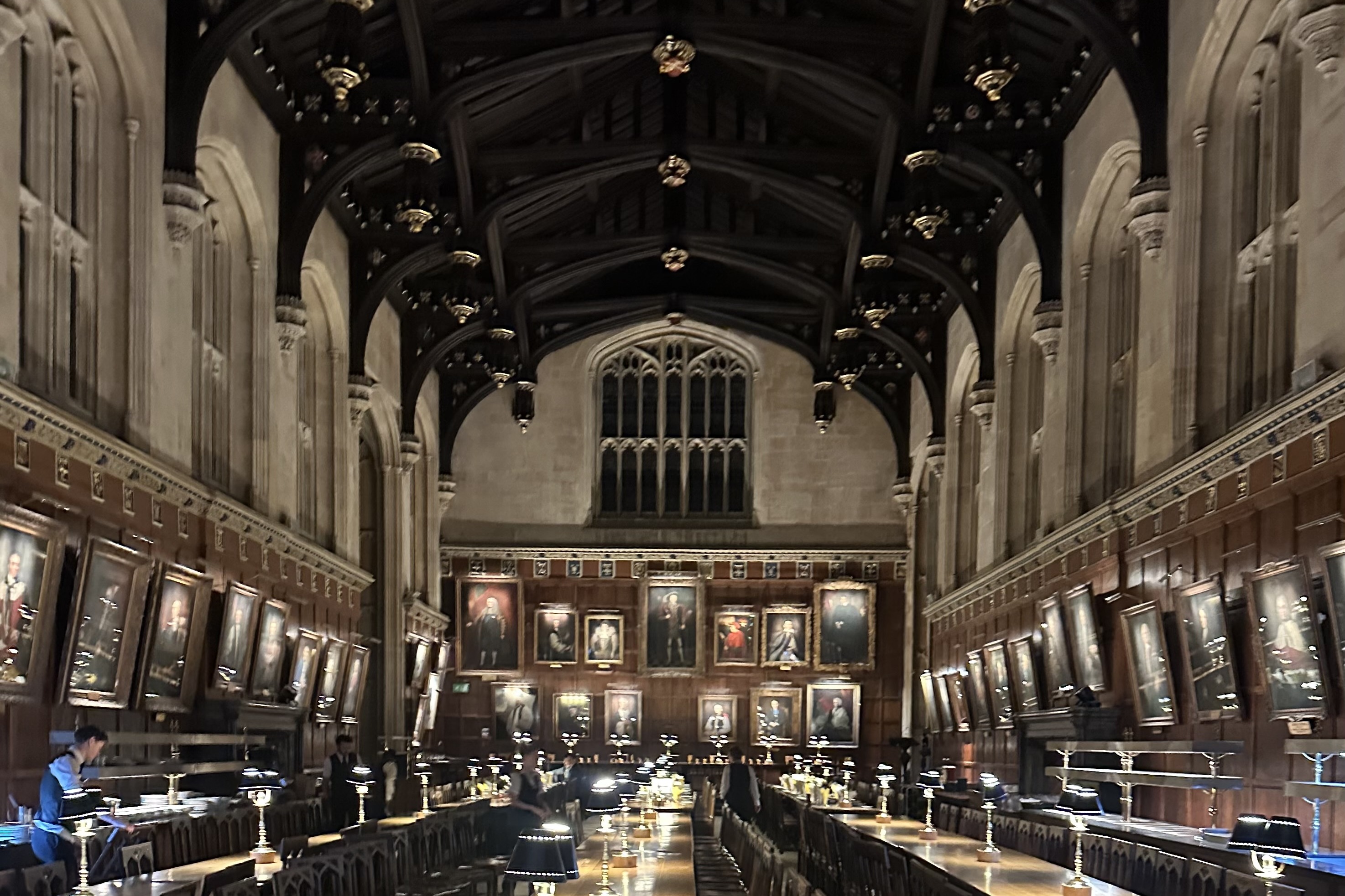 The dining hall of Christ Church, Oxford, with portraits along the walls and long tables under a timber roof
